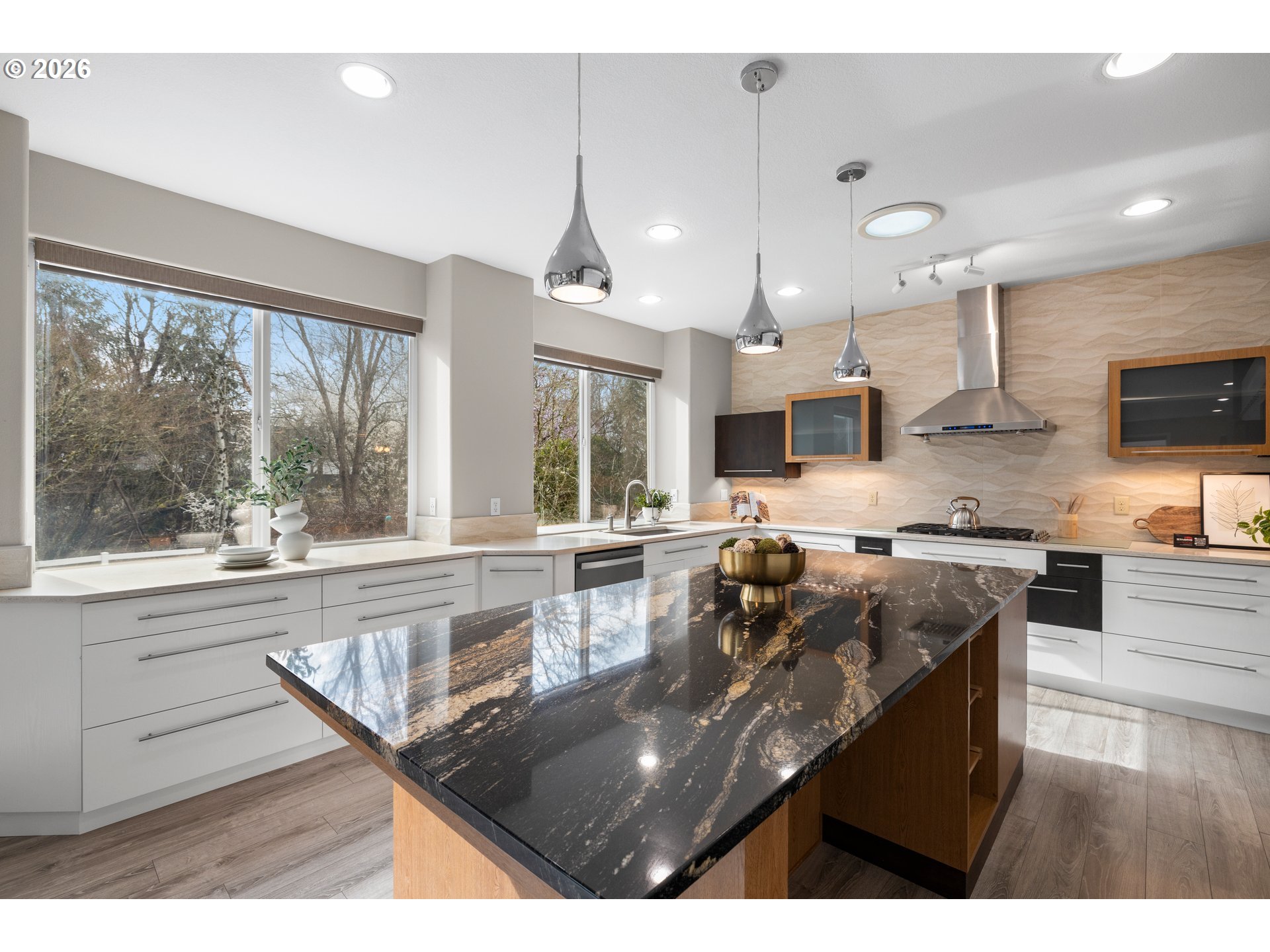 15542 Northwest Andalusian Way Portland, OR 97229 - Photo 20 of 48 a kitchen with stainless steel appliances granite countertop a sink a stove and a wooden cabinets