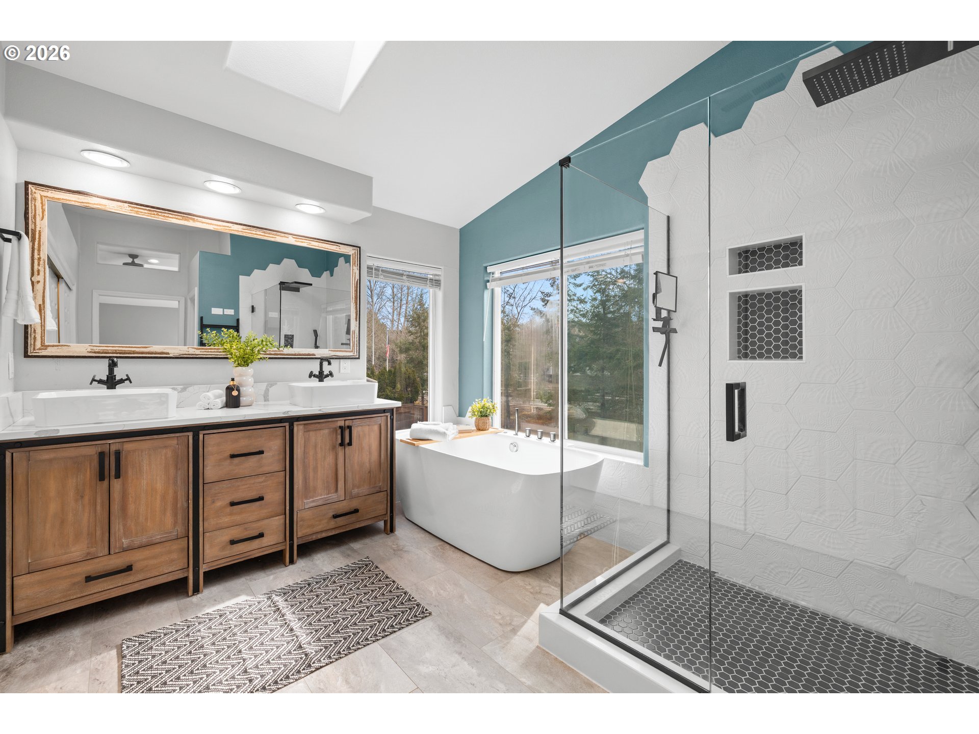 15542 Northwest Andalusian Way Portland, OR 97229 - Photo 31 of 48 a spacious bathroom with a double vanity sink a mirror and a bathtub