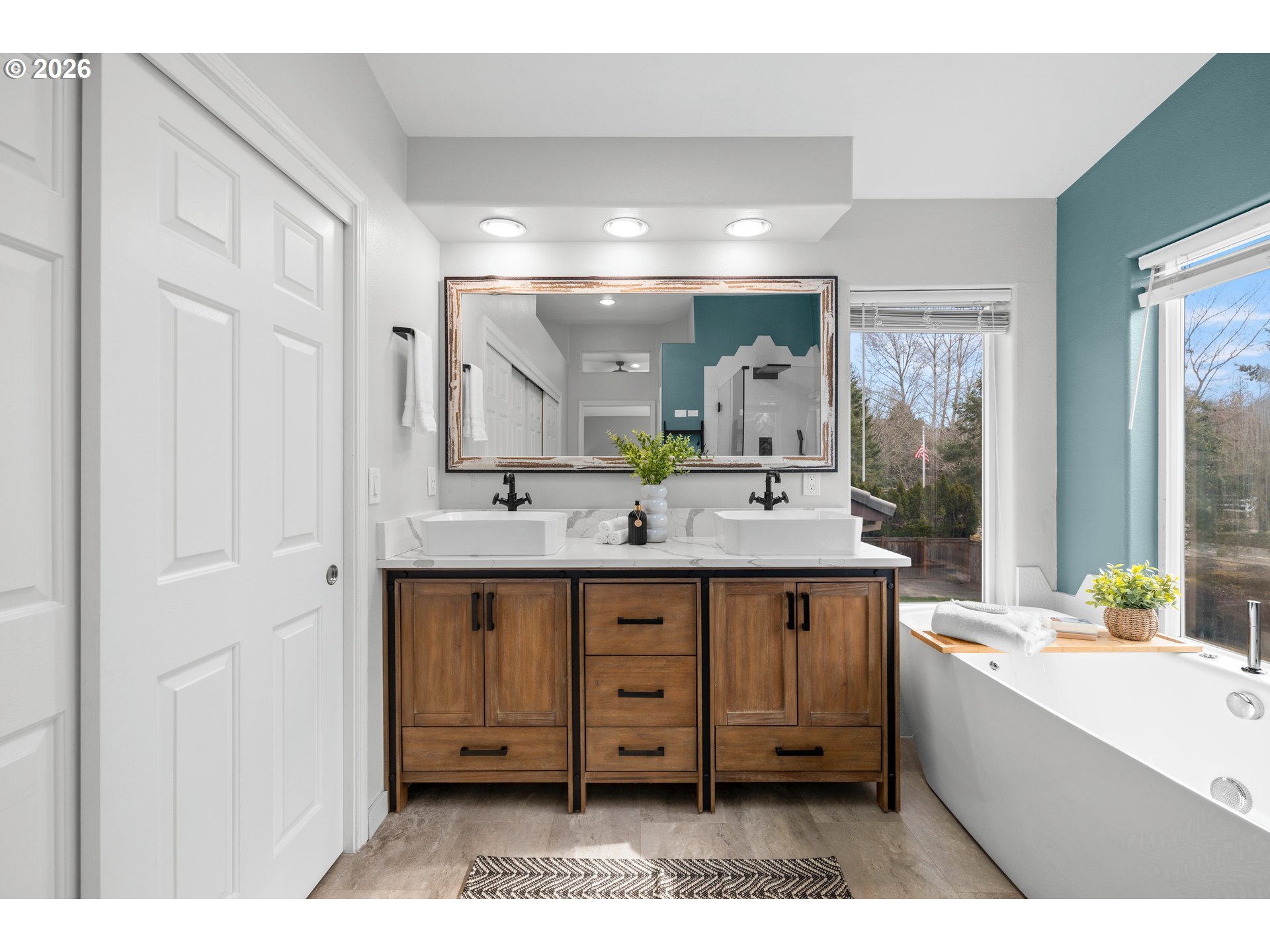 15542 Northwest Andalusian Way Portland, OR 97229 - Photo 32 of 48 a spacious bathroom with a granite countertop sink a mirror and a