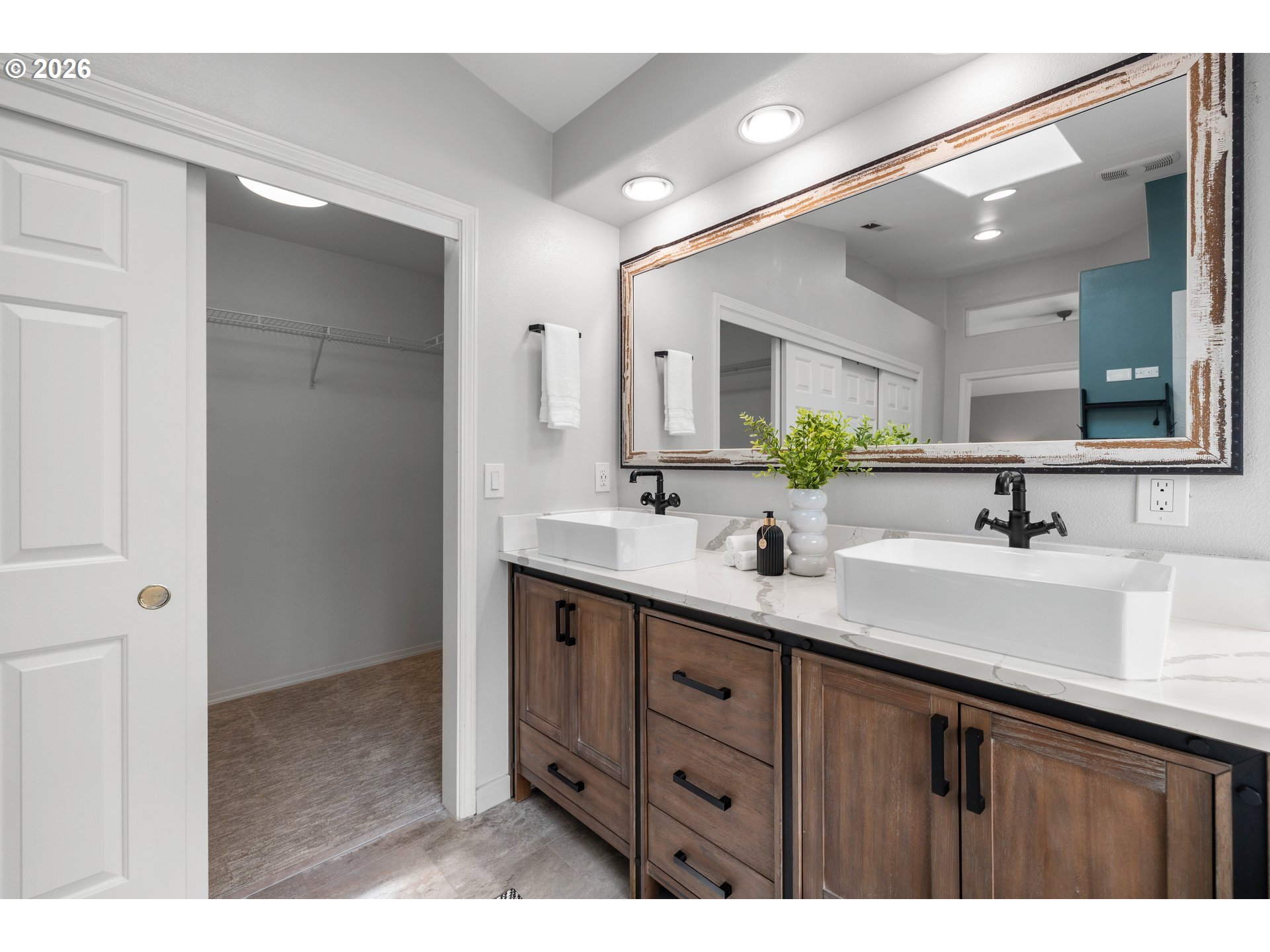 15542 Northwest Andalusian Way Portland, OR 97229 - Photo 33 of 48 a bathroom with a double vanity sink and mirror