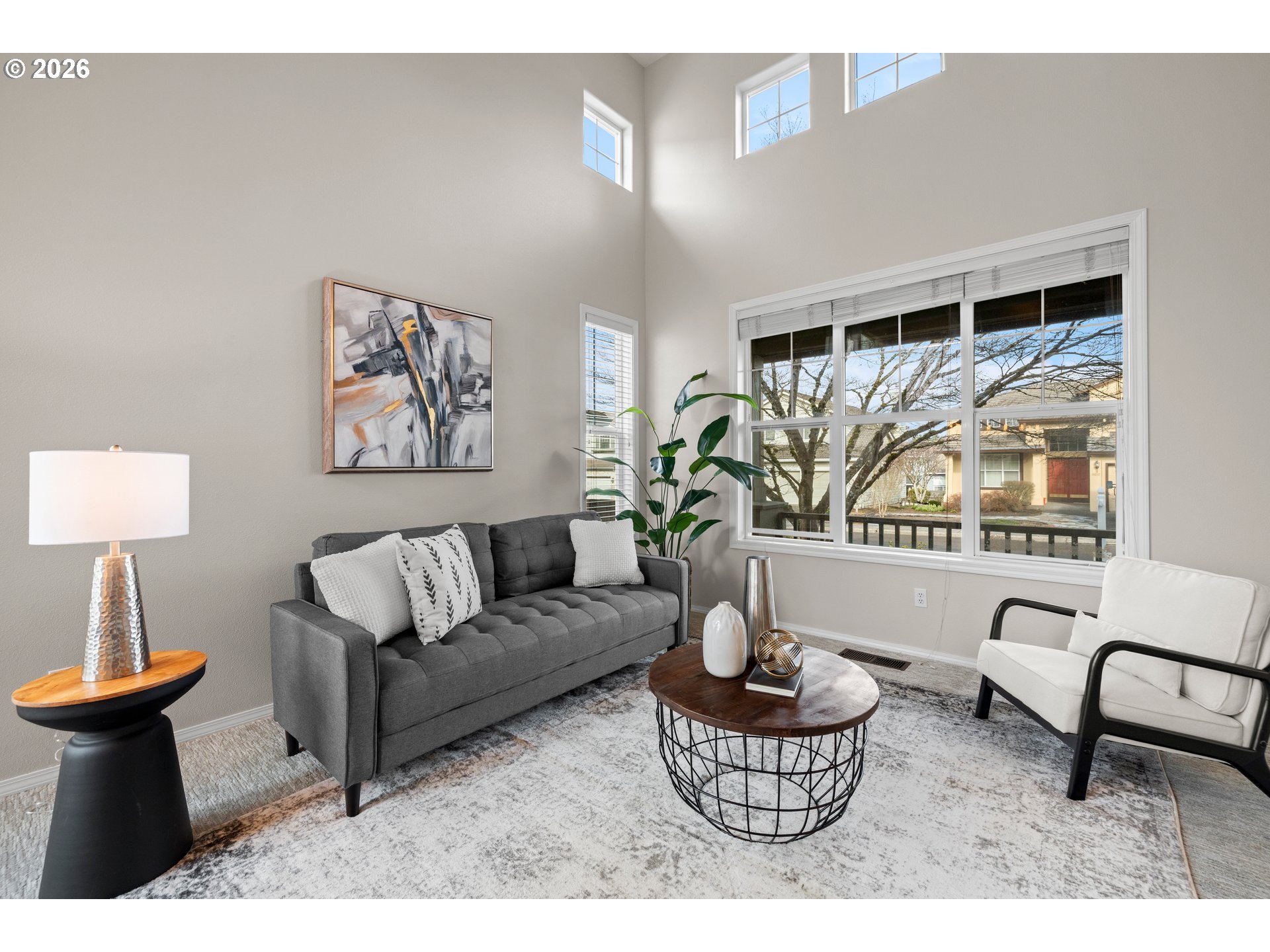 15542 Northwest Andalusian Way Portland, OR 97229 - Photo 8 of 48 a living room with furniture and a large window