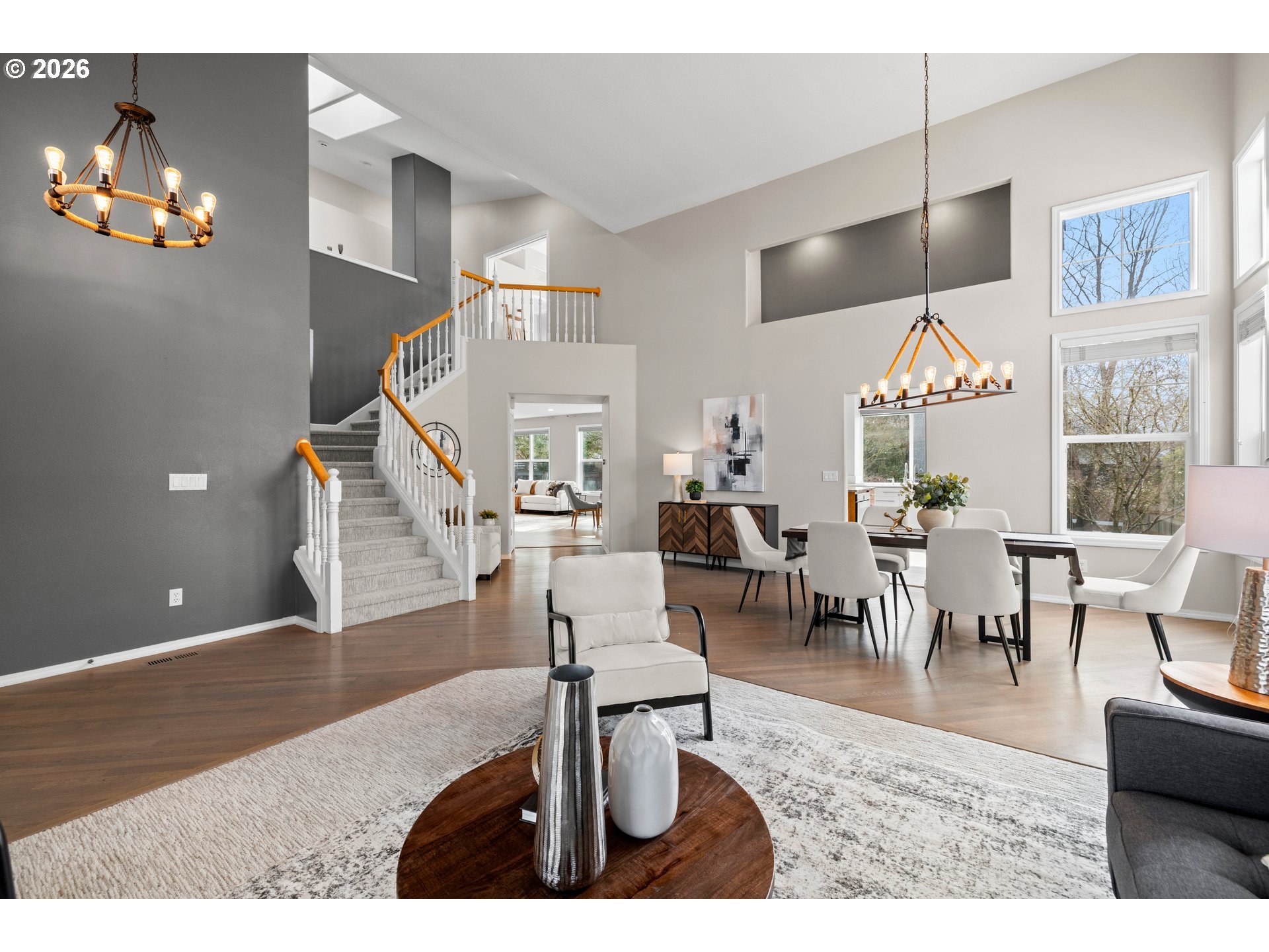 15542 Northwest Andalusian Way Portland, OR 97229 - Photo 10 of 48 a living room with furniture and a chandelier