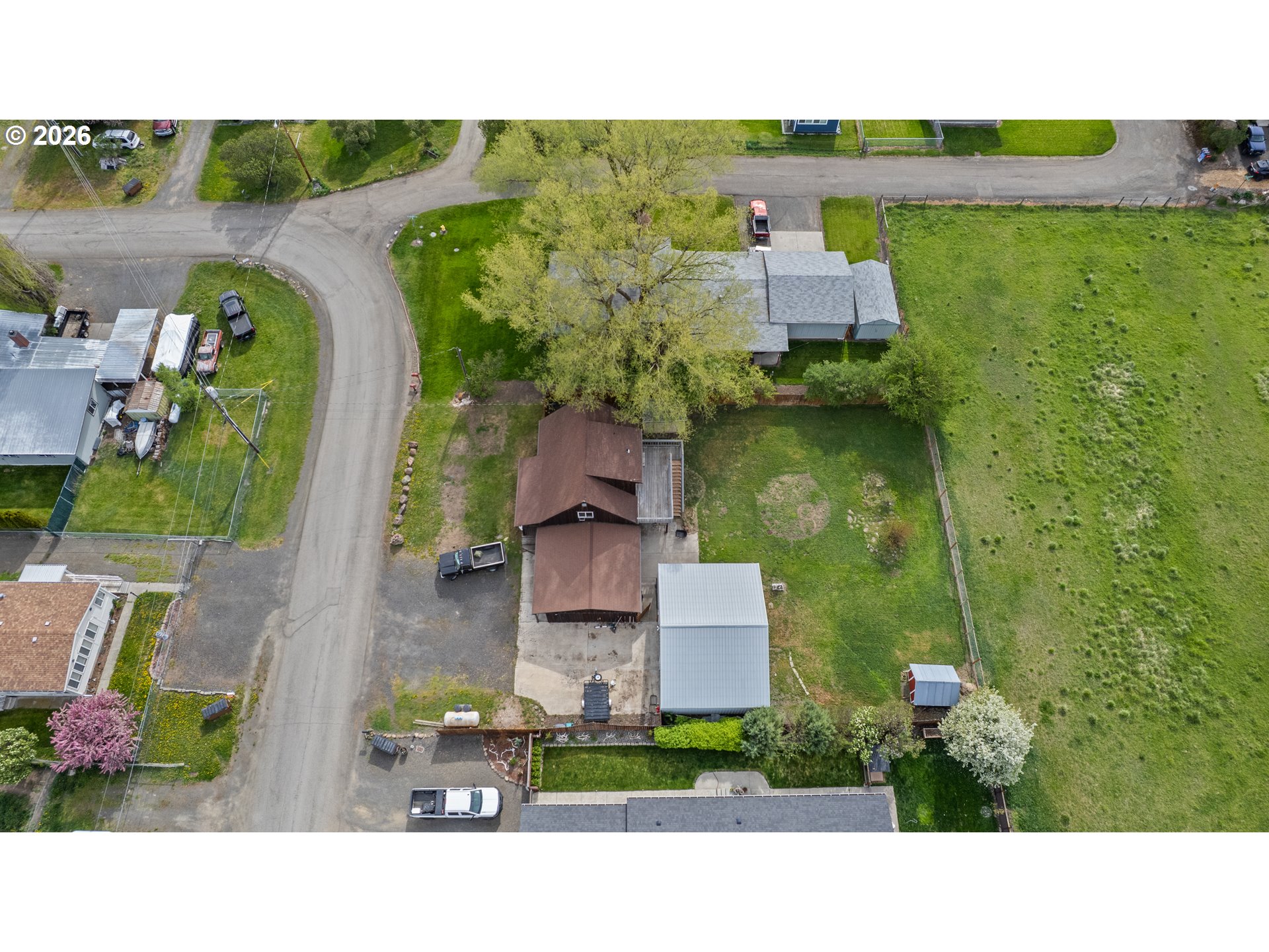 604 Mildred Street Enterprise, OR 97828 - Photo 27 of 37 an aerial view of a house with a garden and a yard