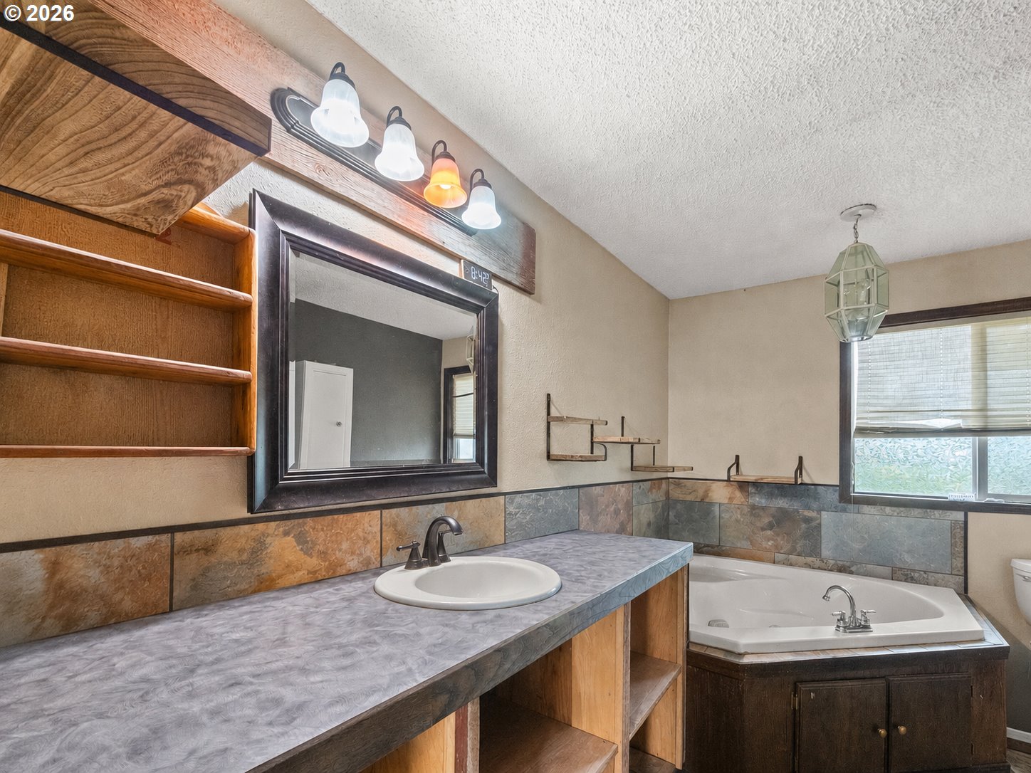 604 Mildred Street Enterprise, OR 97828 - Photo 8 of 37 a bathroom with a sink and a mirror