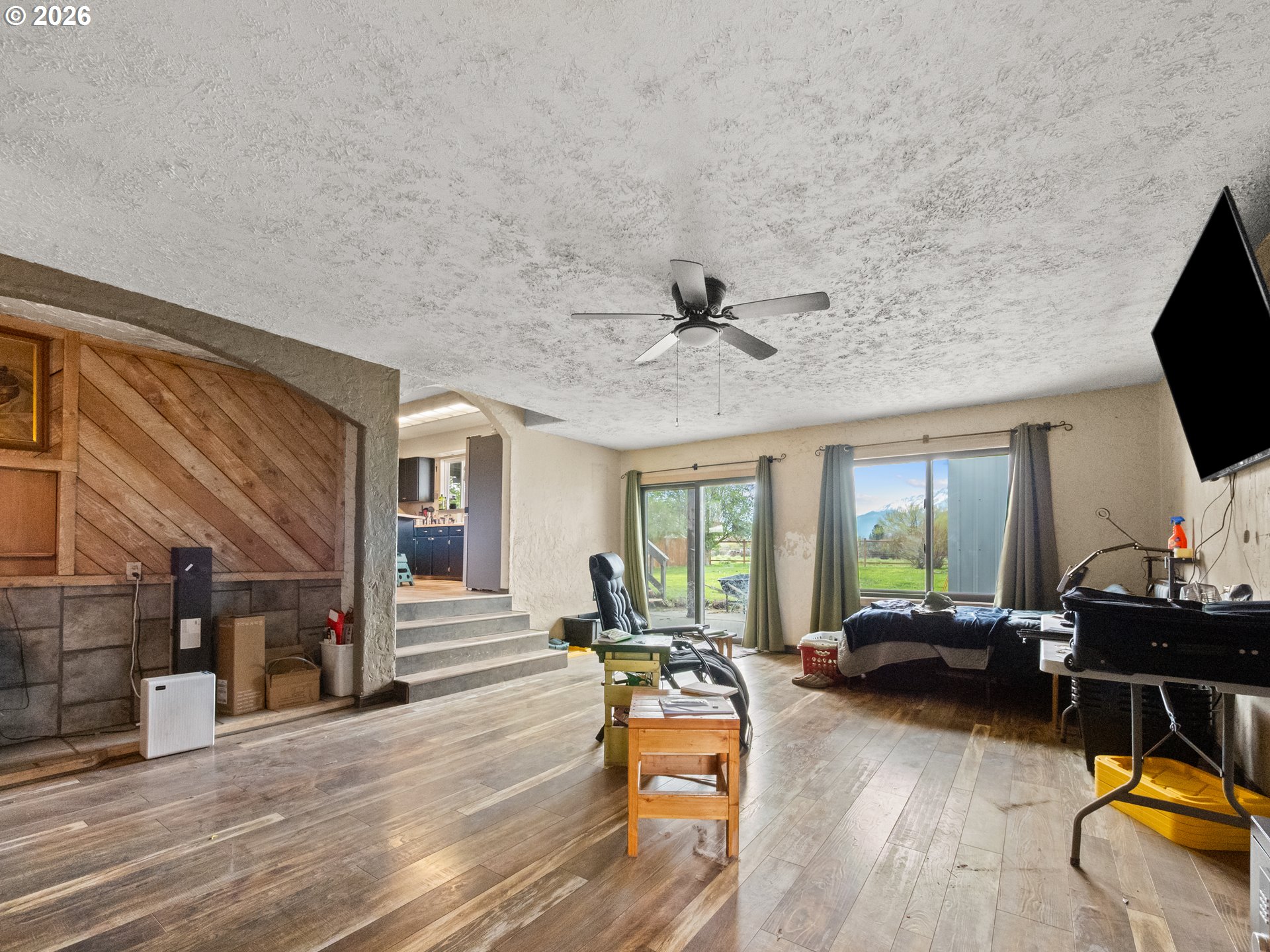 604 Mildred Street Enterprise, OR 97828 - Photo 9 of 37 a living room with furniture a fireplace and a floor to ceiling window