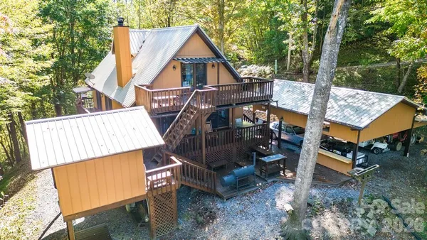 aerial view of a house with backyard and deck
