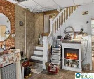 19 East Patterson Street Lansford, PA 18232 - Photo 3 of 17 a living room with furniture and a fireplace