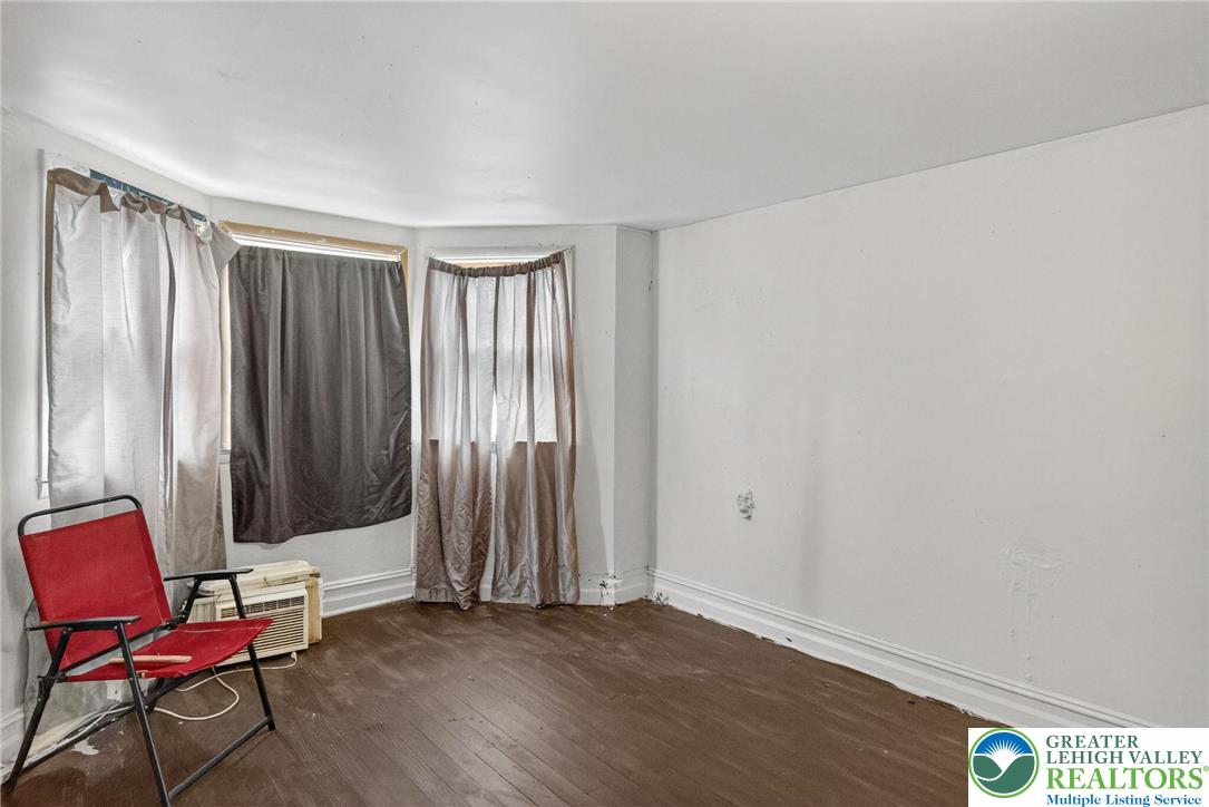 19 East Patterson Street Lansford, PA 18232 - Photo 7 of 17 an empty room with wooden floor and windows