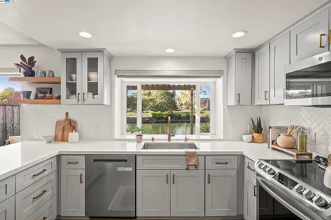 a kitchen with a sink stove and cabinets