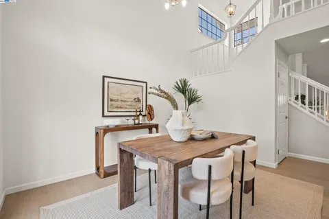 a dining room with furniture and wooden floor