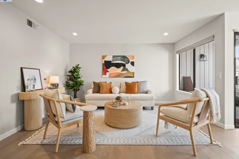 a living room with furniture and a potted plant