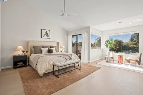 a bedroom with a large bed and a large window