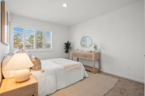 a bedroom with a bed and a table