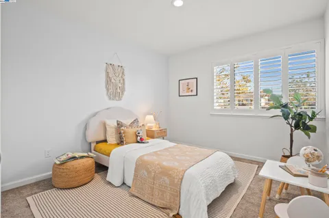 a bedroom with bed and a window