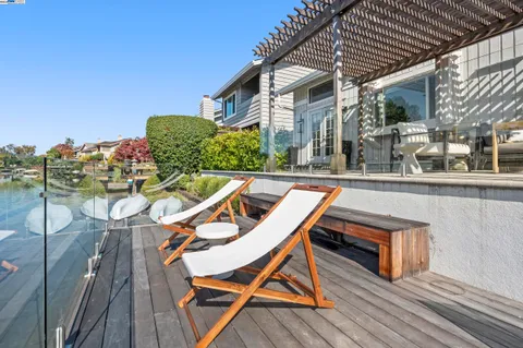 a patio with glass top table and chairs