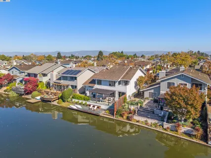 an aerial view of residential houses with outdoor space and swimming pool