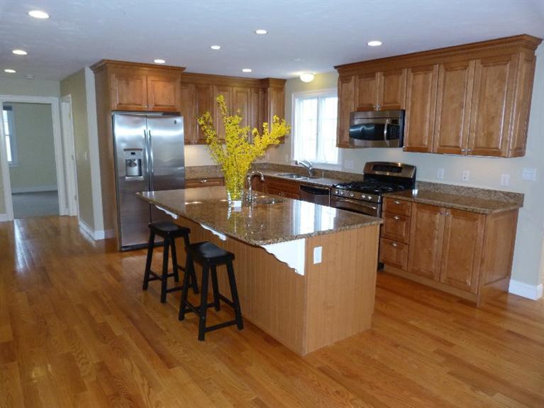 1399 Halls Path Harwich, MA 02645 - Photo 11 of 34 a kitchen with stainless steel appliances granite countertop wooden cabinets a refrigerator a stove a sink and a microwave