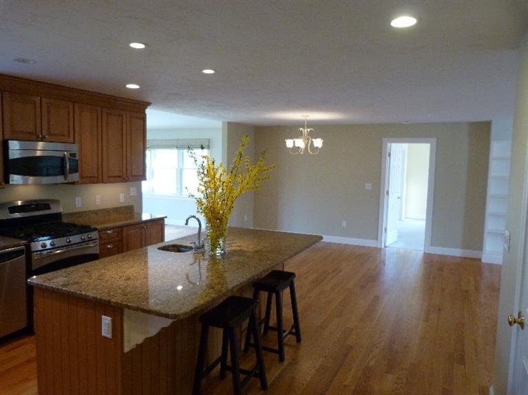 1399 Halls Path Harwich, MA 02645 - Photo 14 of 34 a kitchen with kitchen island granite countertop a stove a sink a refrigerator and wooden floor