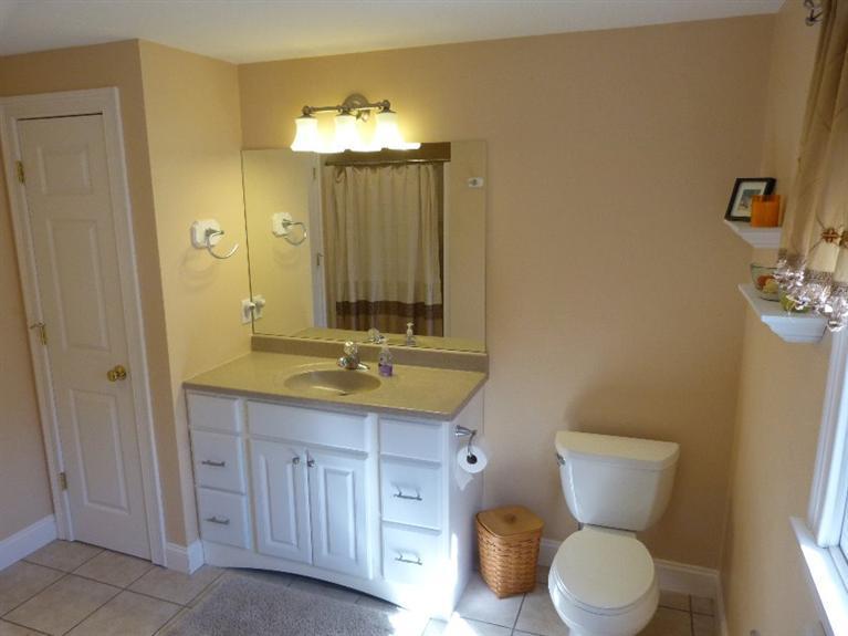 1399 Halls Path Harwich, MA 02645 - Photo 25 of 34 a bathroom with a granite countertop toilet sink and mirror