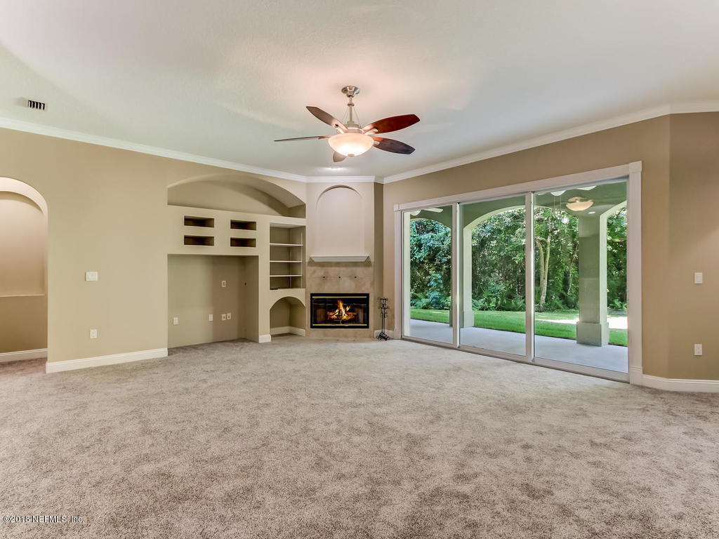 1576 Scott Road Fruit Cove, FL 32259 - Photo 15 of 87 a view of a livingroom with a fireplace and a large window