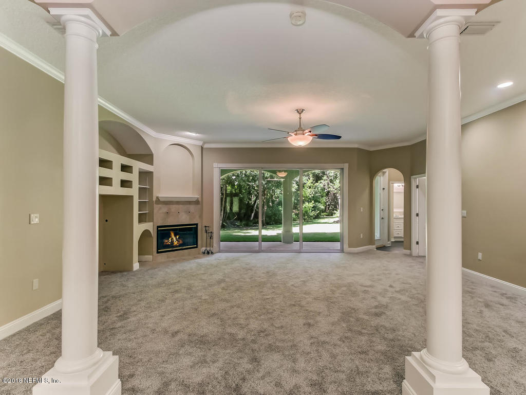 1576 Scott Road Fruit Cove, FL 32259 - Photo 18 of 87 a view of a livingroom with a fireplace and large windows