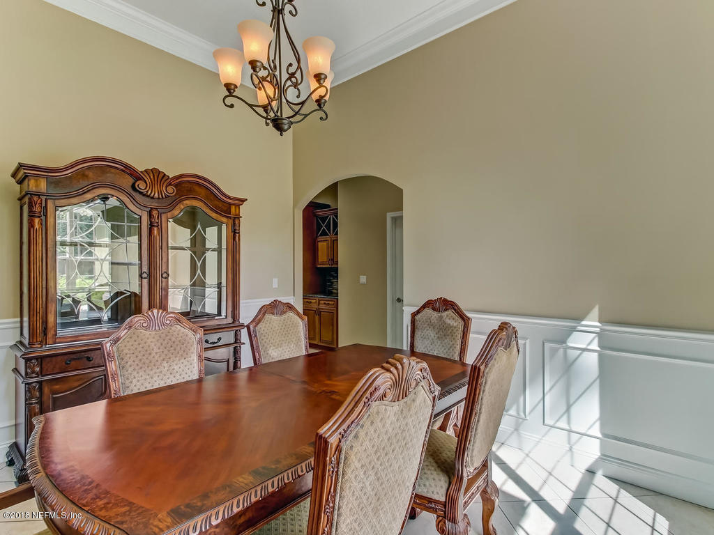 1576 Scott Road Fruit Cove, FL 32259 - Photo 20 of 87 a dining room with furniture and chandelier
