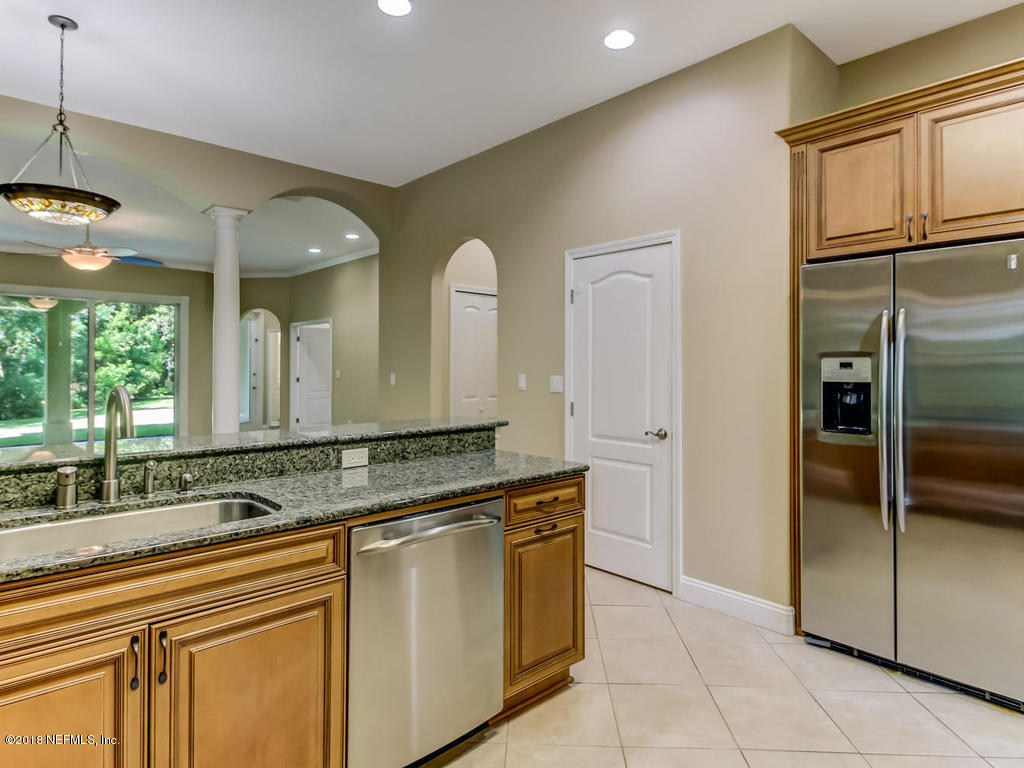 1576 Scott Road Fruit Cove, FL 32259 - Photo 23 of 87 a kitchen with stainless steel appliances granite countertop a sink and a refrigerator