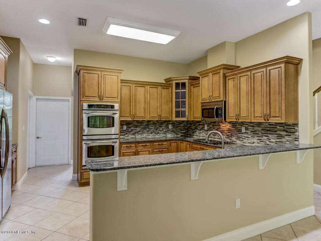 1576 Scott Road Fruit Cove, FL 32259 - Photo 27 of 87 a kitchen with stainless steel appliances granite countertop a refrigerator and a sink