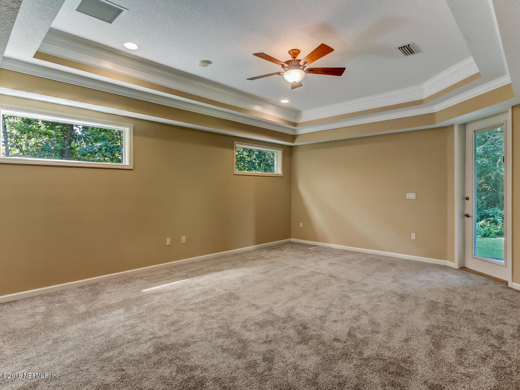 1576 Scott Road Fruit Cove, FL 32259 - Photo 29 of 87 a view of an empty room with a chandelier fan and a window