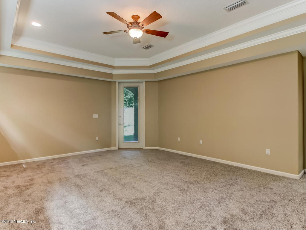 1576 Scott Road Fruit Cove, FL 32259 - Photo 30 of 87 an empty room with a chandelier fan and a ceiling fan