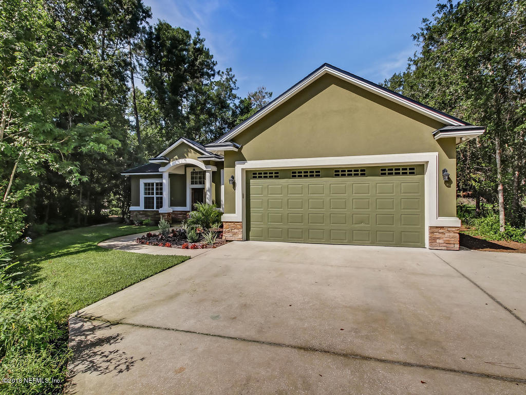 1576 Scott Road Fruit Cove, FL 32259 - Photo 3 of 87 a front view of a house with yard and green space