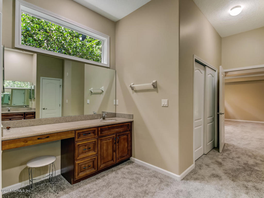 1576 Scott Road Fruit Cove, FL 32259 - Photo 33 of 87 a spacious bathroom with a double vanity sink and a mirror