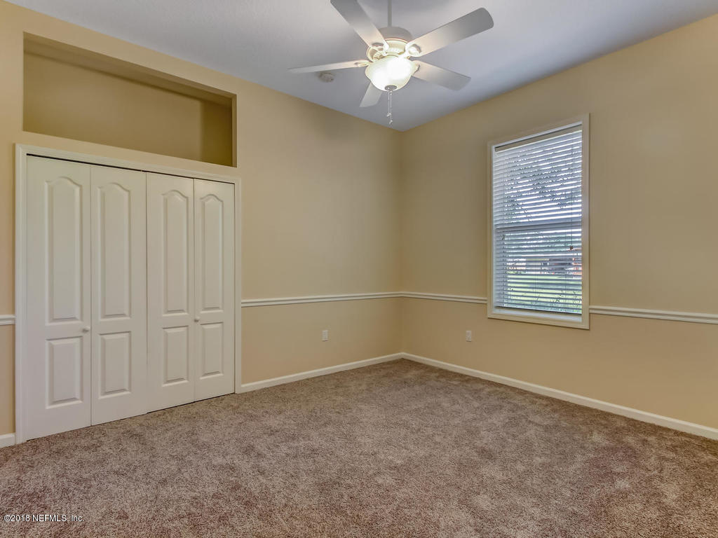 1576 Scott Road Fruit Cove, FL 32259 - Photo 44 of 87 an empty room with windows and fan