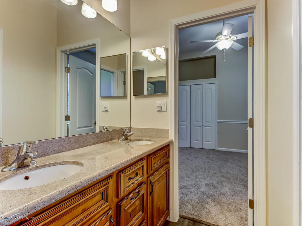 1576 Scott Road Fruit Cove, FL 32259 - Photo 45 of 87 a bathroom with a sink and a mirror