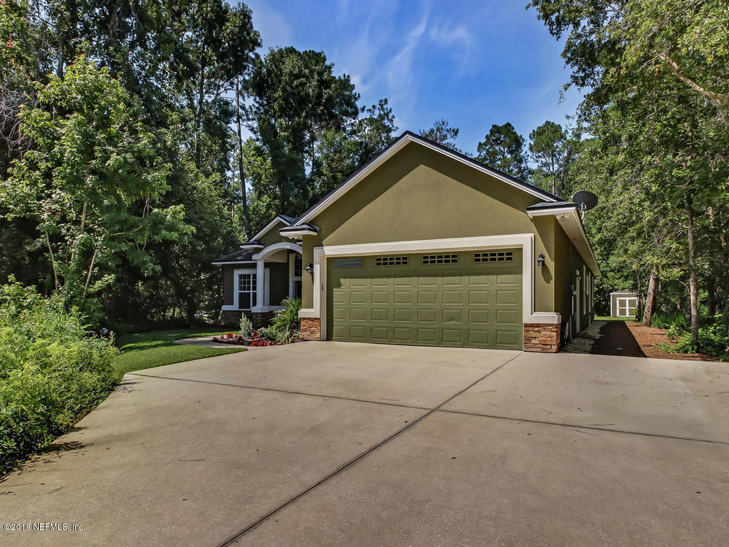1576 Scott Road Fruit Cove, FL 32259 - Photo 6 of 87 a front view of a house with a yard and garage