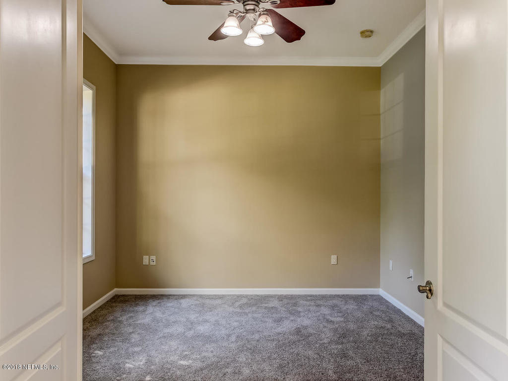 1576 Scott Road Fruit Cove, FL 32259 - Photo 10 of 87 an empty room with a ceiling fan and carpet
