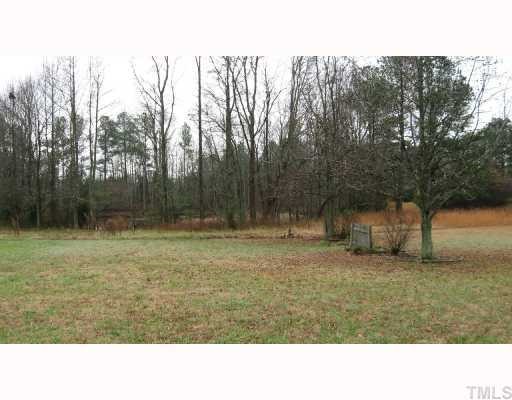 7516 Eagle Run Road Zebulon, NC 27597 - Photo 2 of 11 a black and white photo of a big yard