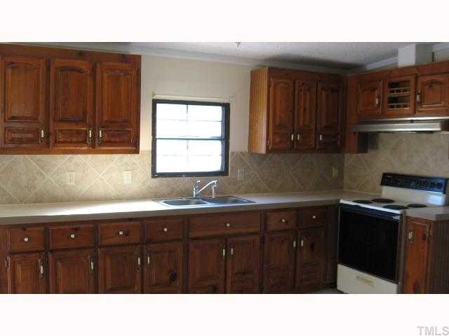 7516 Eagle Run Road Zebulon, NC 27597 - Photo 4 of 11 a kitchen with a sink and cabinets