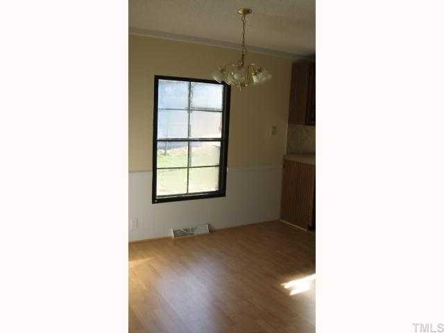 7516 Eagle Run Road Zebulon, NC 27597 - Photo 6 of 11 a view of an empty room with a window