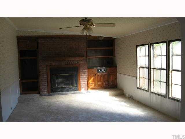 7516 Eagle Run Road Zebulon, NC 27597 - Photo 8 of 11 a open kitchen with a fireplace and window