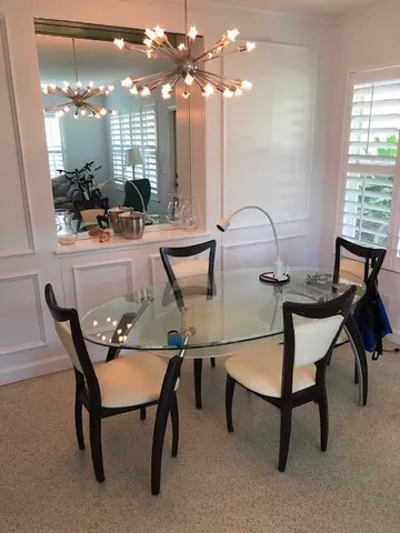 a view of a dining room with furniture and chandelier