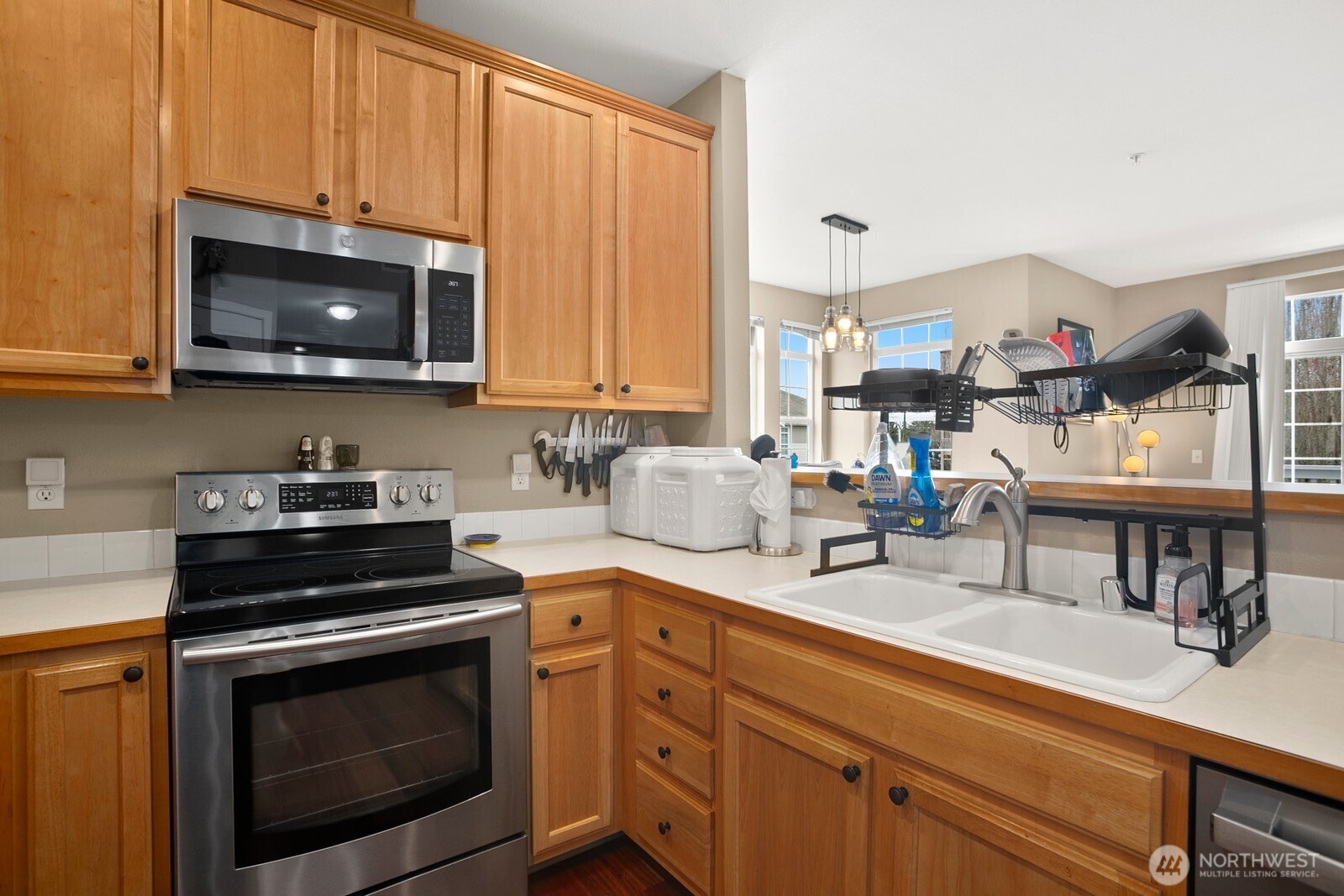 6830 20th Street East, Unit F5 Fife, WA 98424 - Photo 13 of 25 a kitchen with stainless steel appliances granite countertop a stove a sink and a microwave