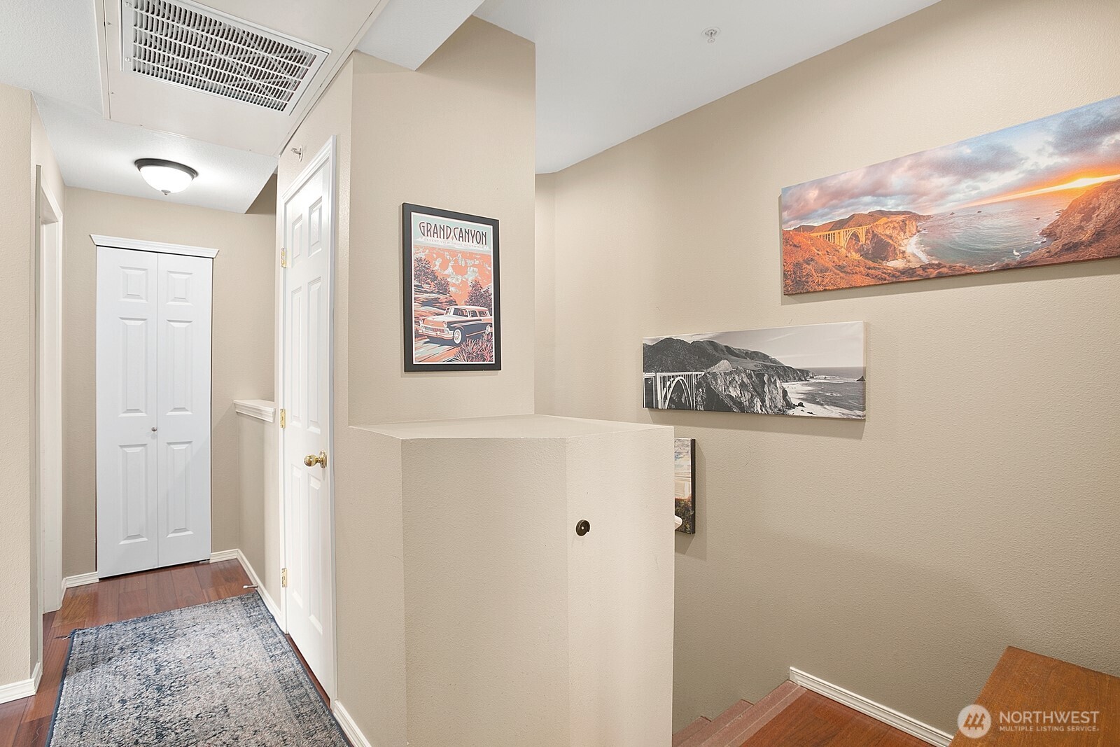 6830 20th Street East, Unit F5 Fife, WA 98424 - Photo 16 of 25 a view of a hallway with paintings on the wall