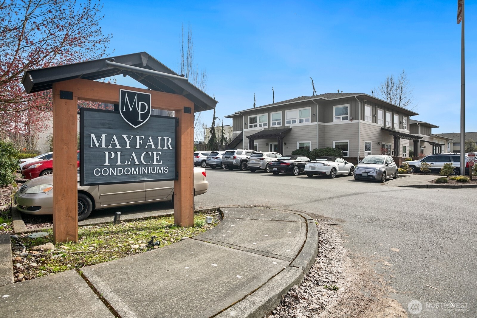 6830 20th Street East, Unit F5 Fife, WA 98424 - Photo 2 of 25 a street sign on a sidewalk next to a road