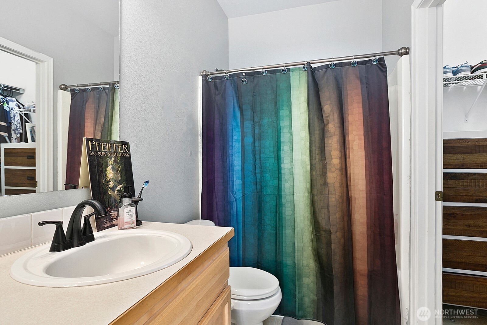 6830 20th Street East, Unit F5 Fife, WA 98424 - Photo 21 of 25 a bathroom with a sink a toilet and shower