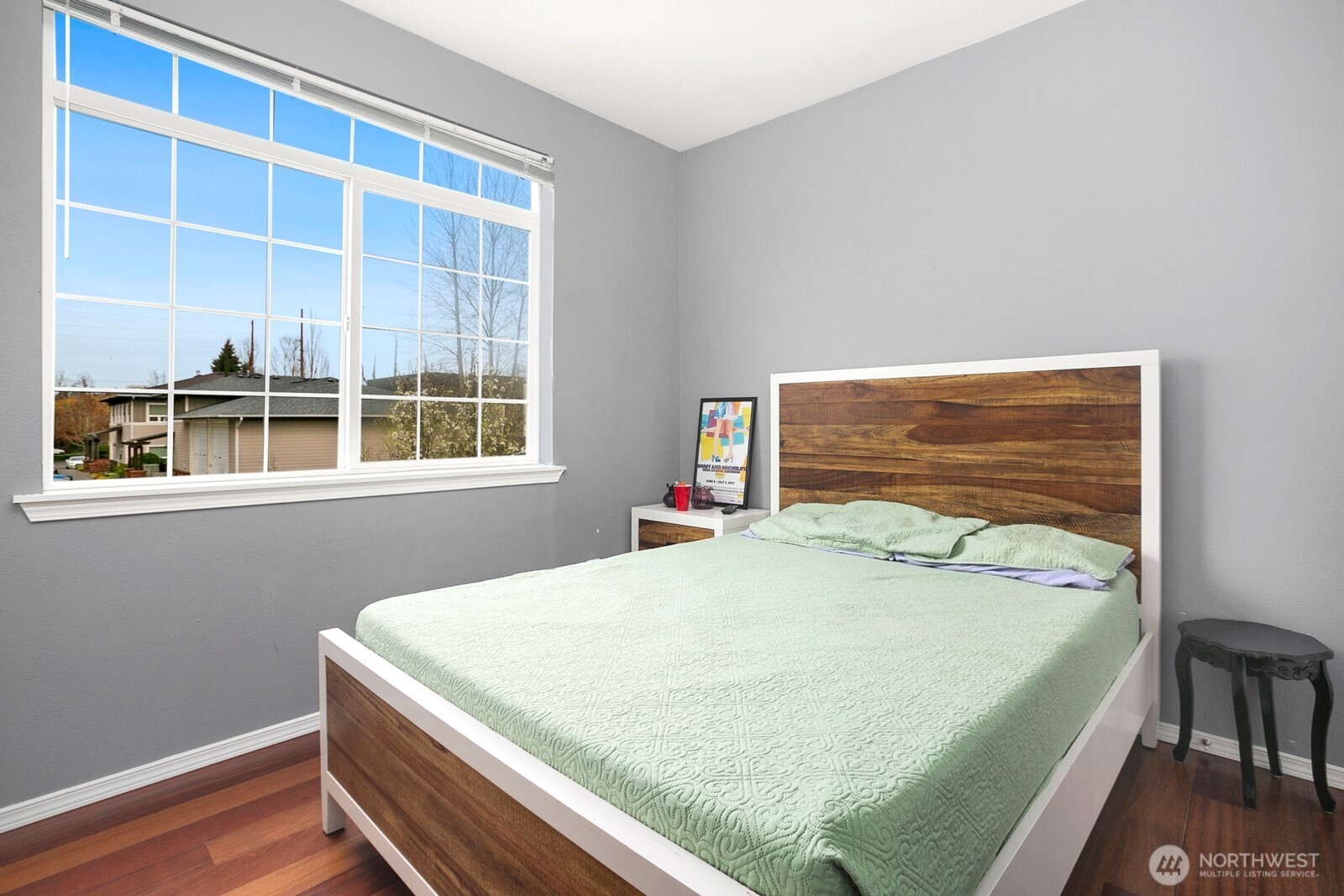 6830 20th Street East, Unit F5 Fife, WA 98424 - Photo 22 of 25 a bed sitting in a bedroom next to a window
