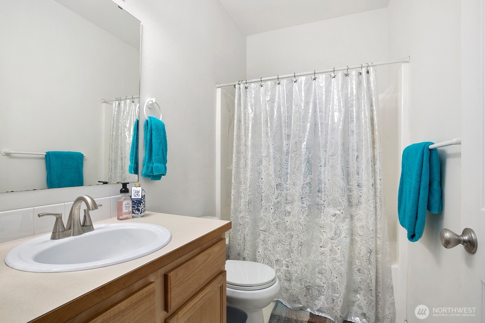 6830 20th Street East, Unit F5 Fife, WA 98424 - Photo 24 of 25 a bathroom with a sink a toilet and a mirror