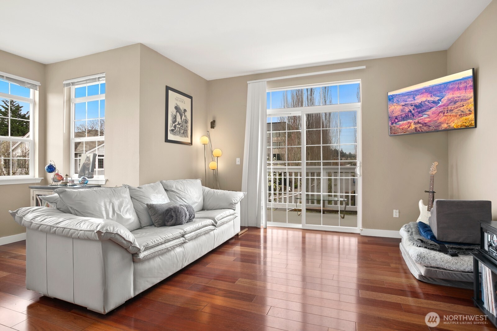 6830 20th Street East, Unit F5 Fife, WA 98424 - Photo 3 of 25 a living room with furniture and a flat screen tv with wooden floor