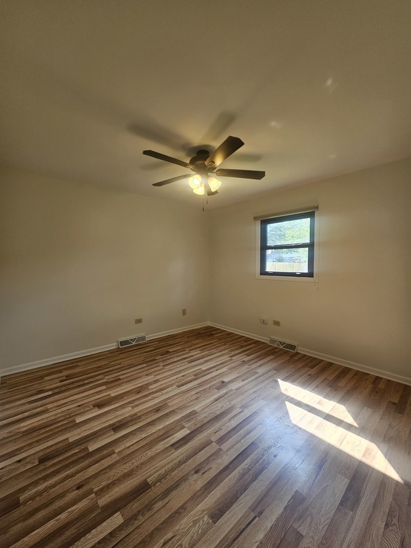 399 Purdue Lane Elgin, IL 60123 - Photo 11 of 24 a view of a room with wooden floor and a window