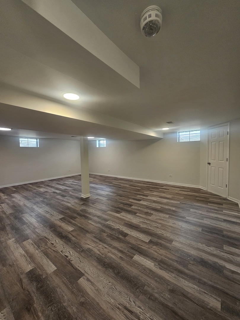 399 Purdue Lane Elgin, IL 60123 - Photo 19 of 24 an empty room with wooden floor and windows